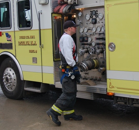 Apparatus Operator FF/EMT Geary giving the pump panel a good looking over.